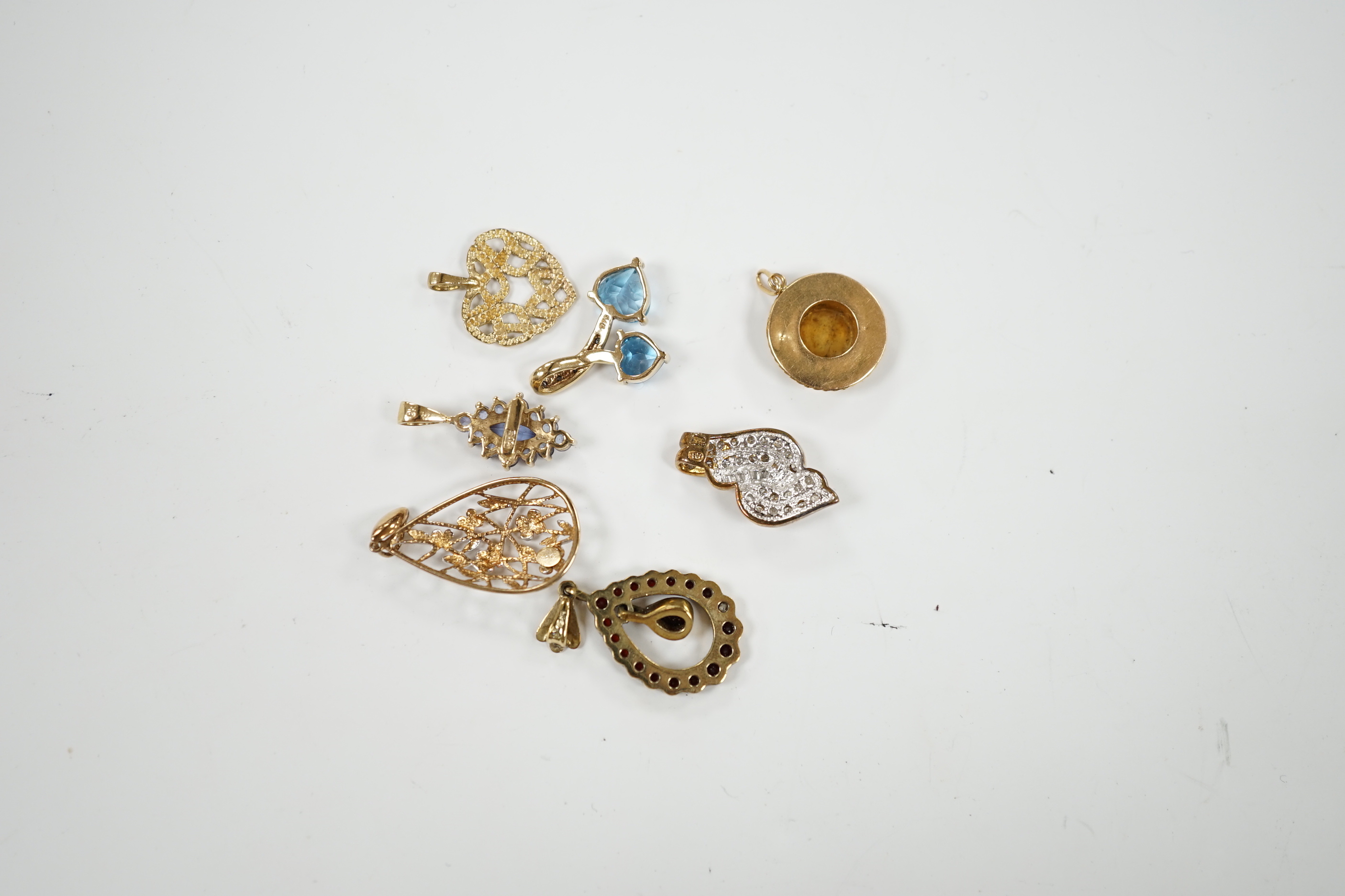 Seven assorted modern mainly 9ct and gem set small pendants, including diamond chip cluster, gross weight 10.4 grams.